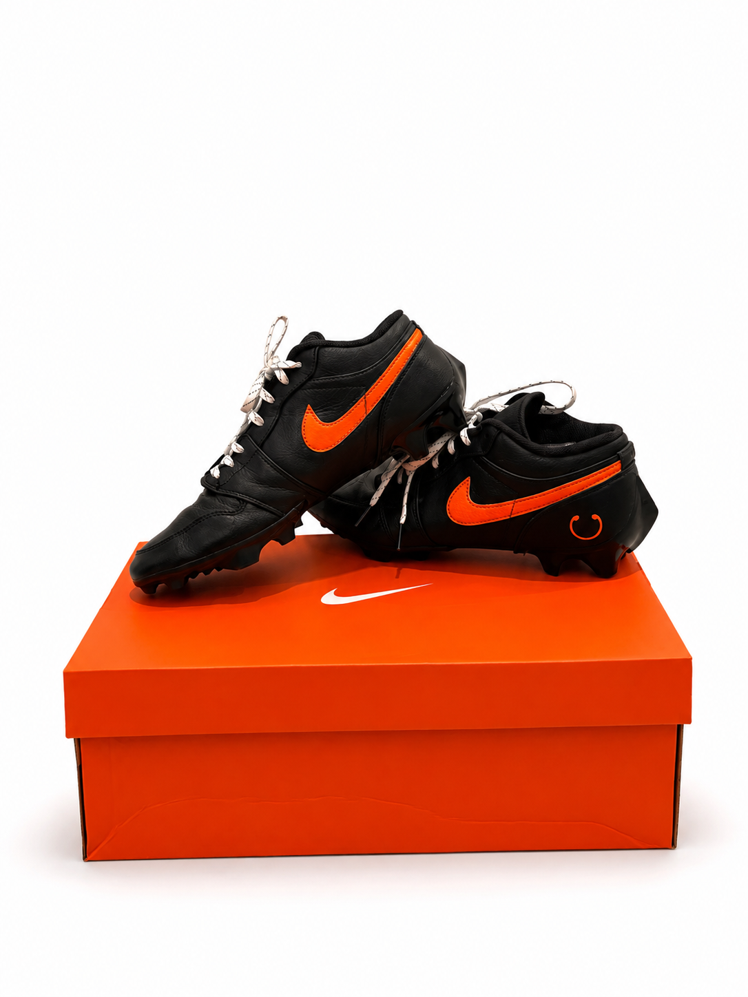 Black custom cleats with orange details
