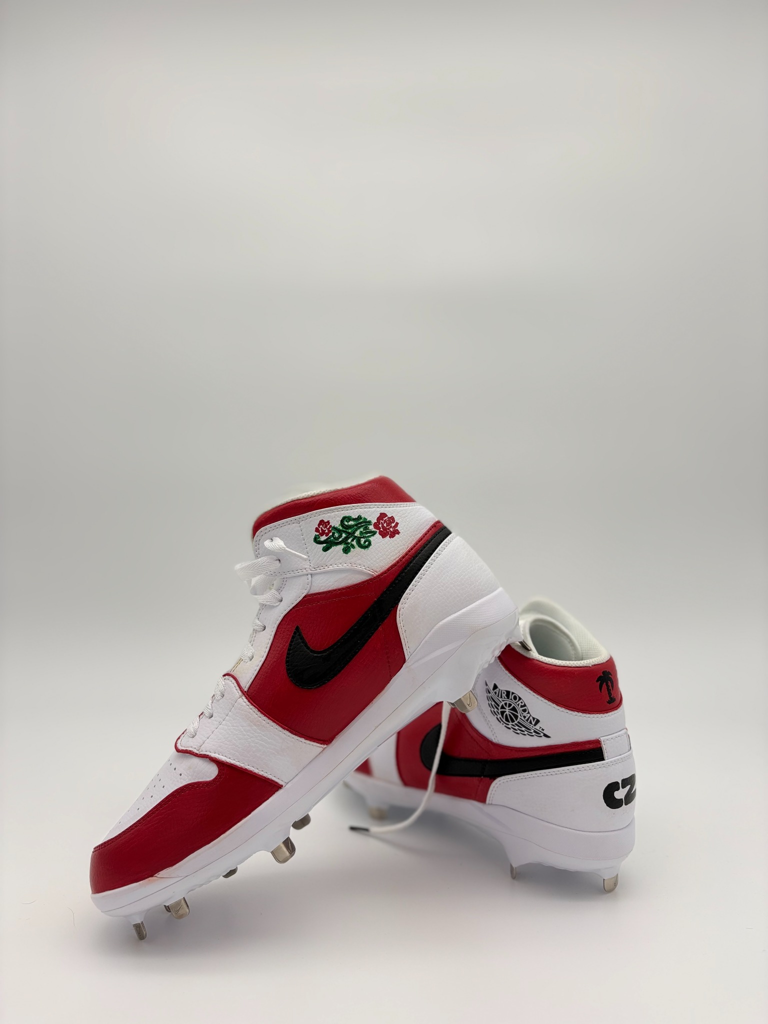 Red and white custom painted cleats by CZembo Art